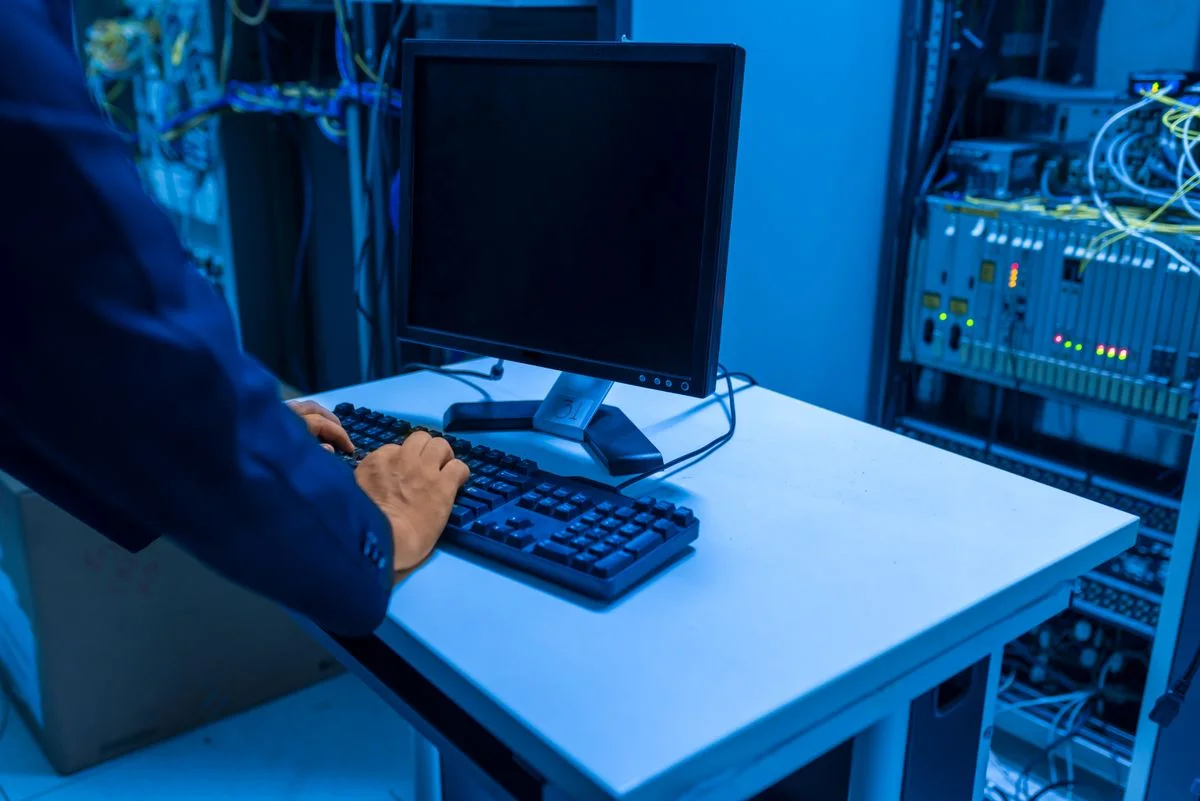 Technician working beside server infrastructure