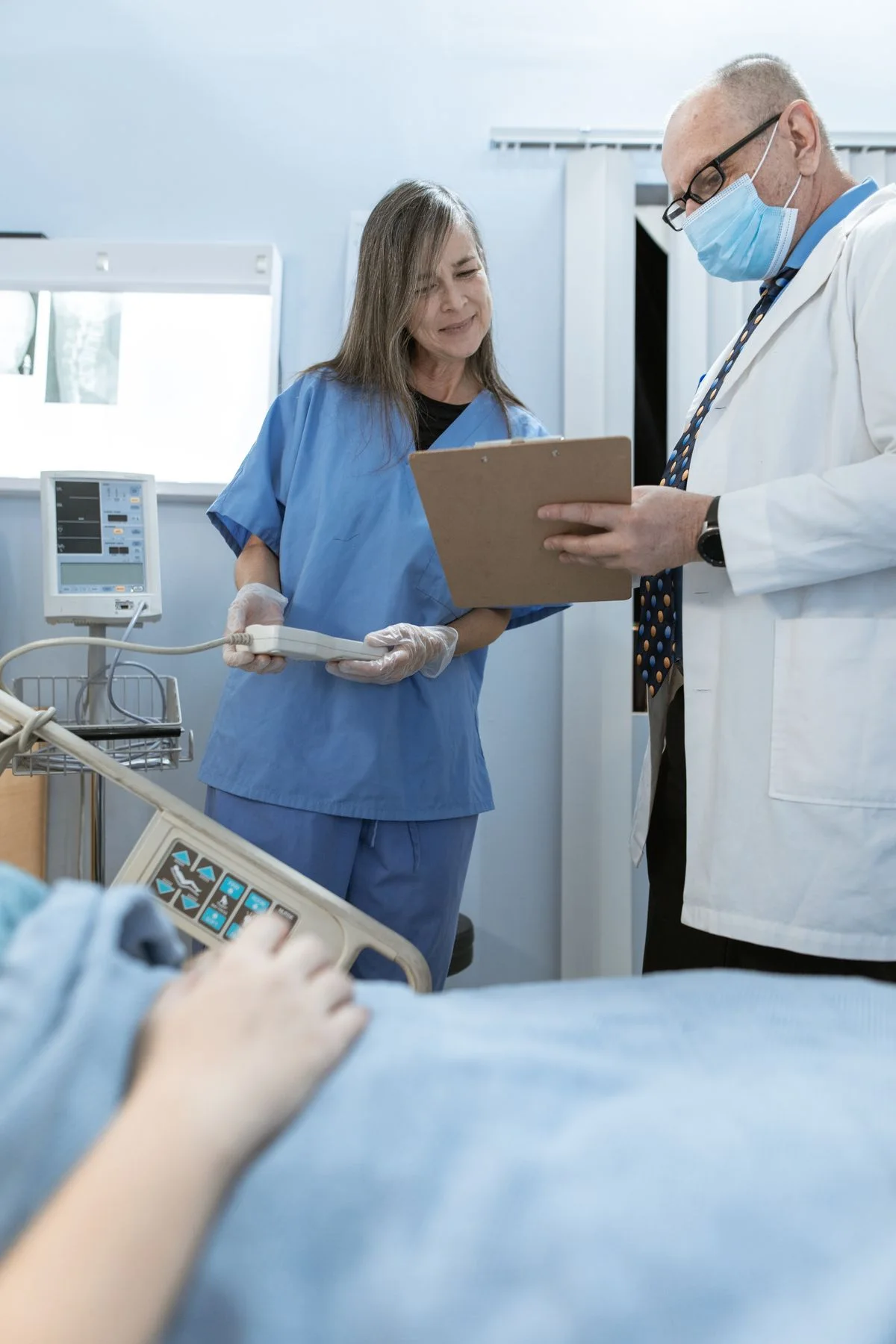 Clinicians reviewing information in a hospital — illustrative photo, not the featured client
